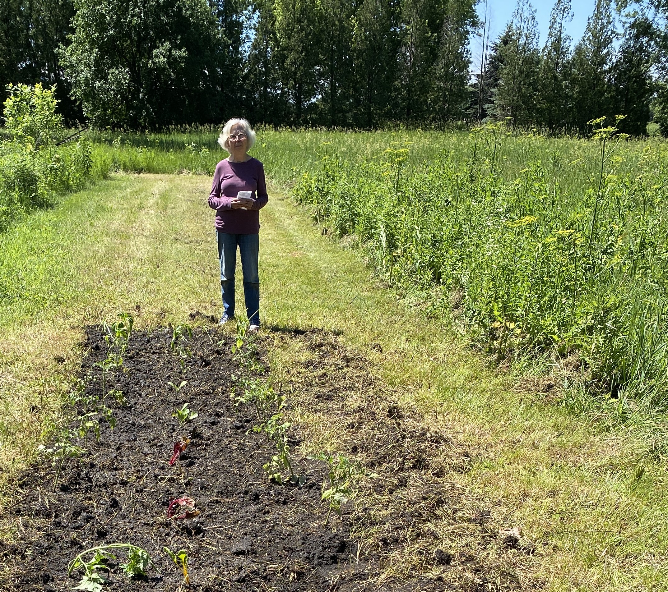 Sally Browne standing in front of her freshly planted garden
