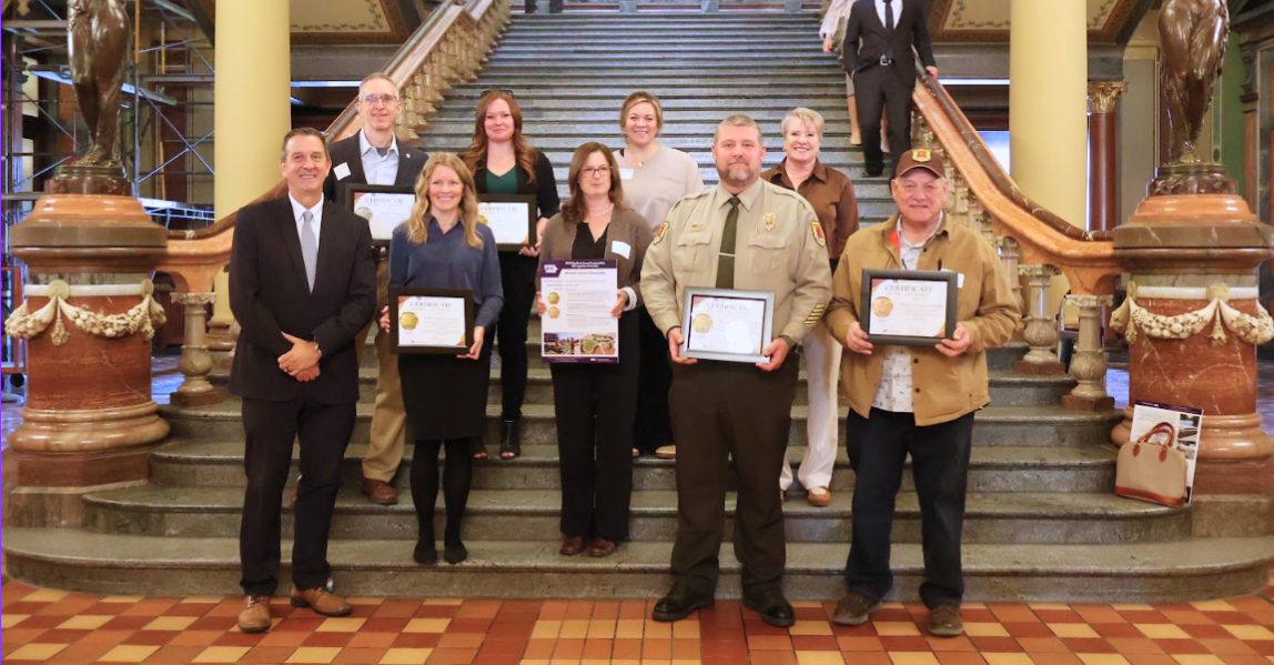 2025 RICognition Award recipients posing with their awards on the steps inside the Iowa State Capitol Building