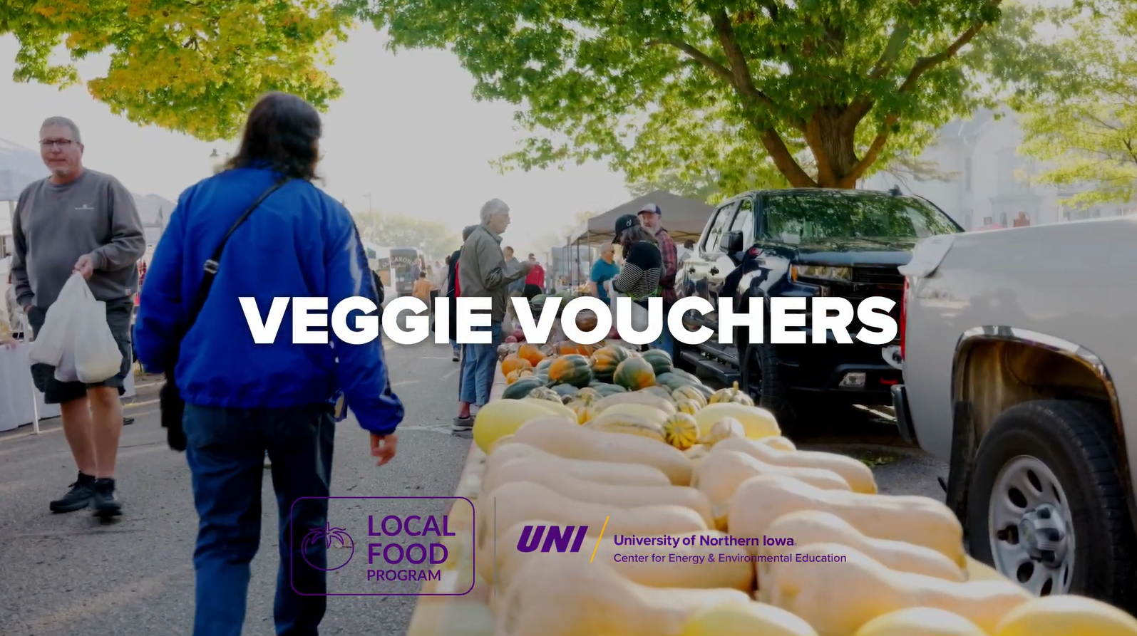 Veggie Vouchers text over a farmers market stand