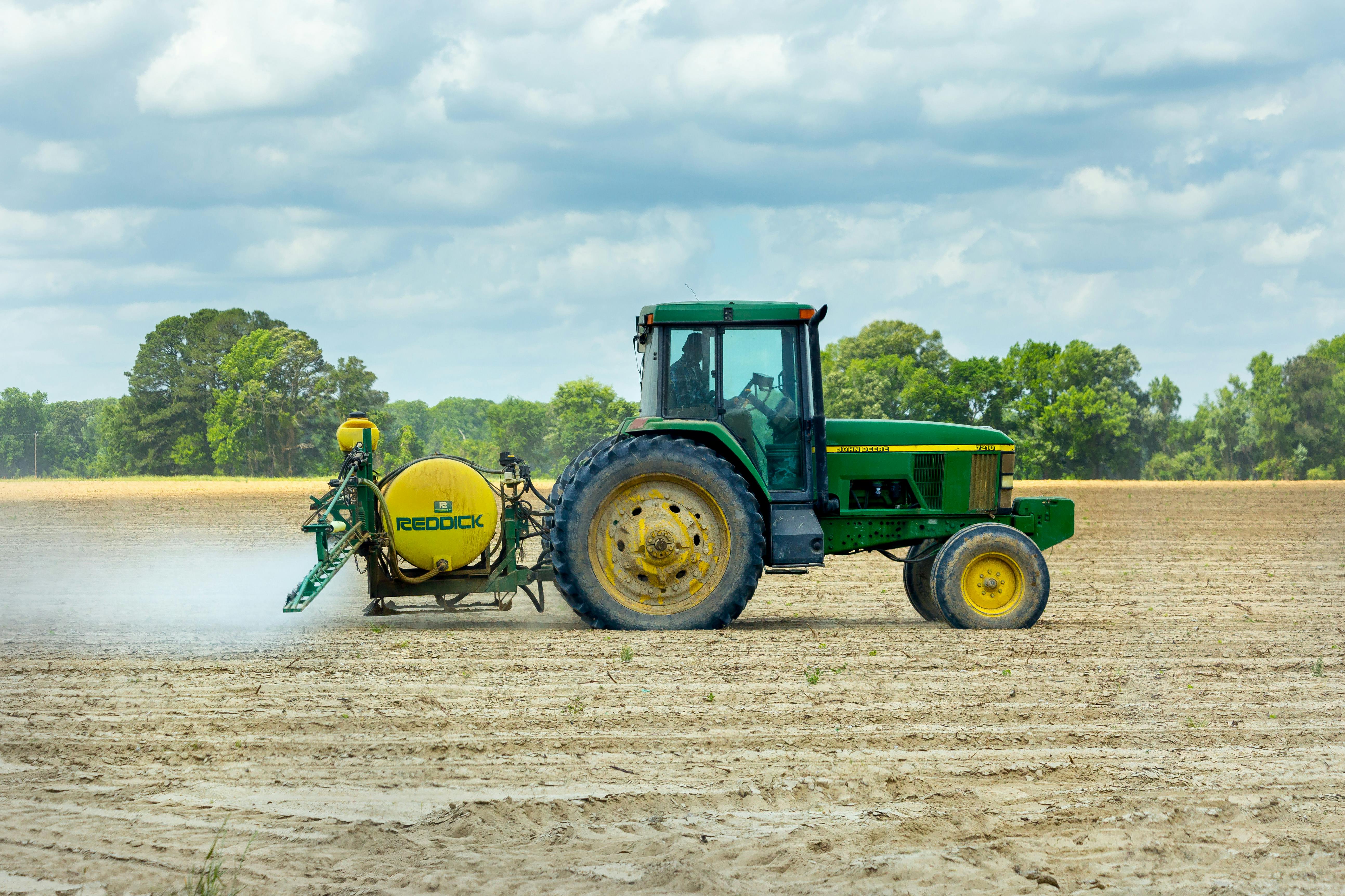 Tractor spraying a crop field