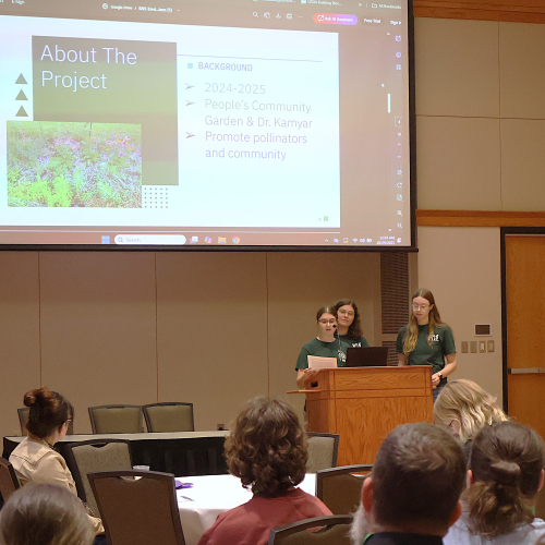 Three speakers at the podium
